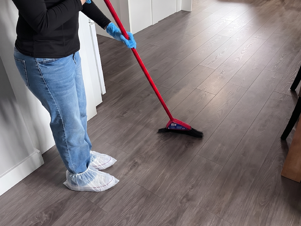 Professional cleaner wiping down a sparkling kitchen counter